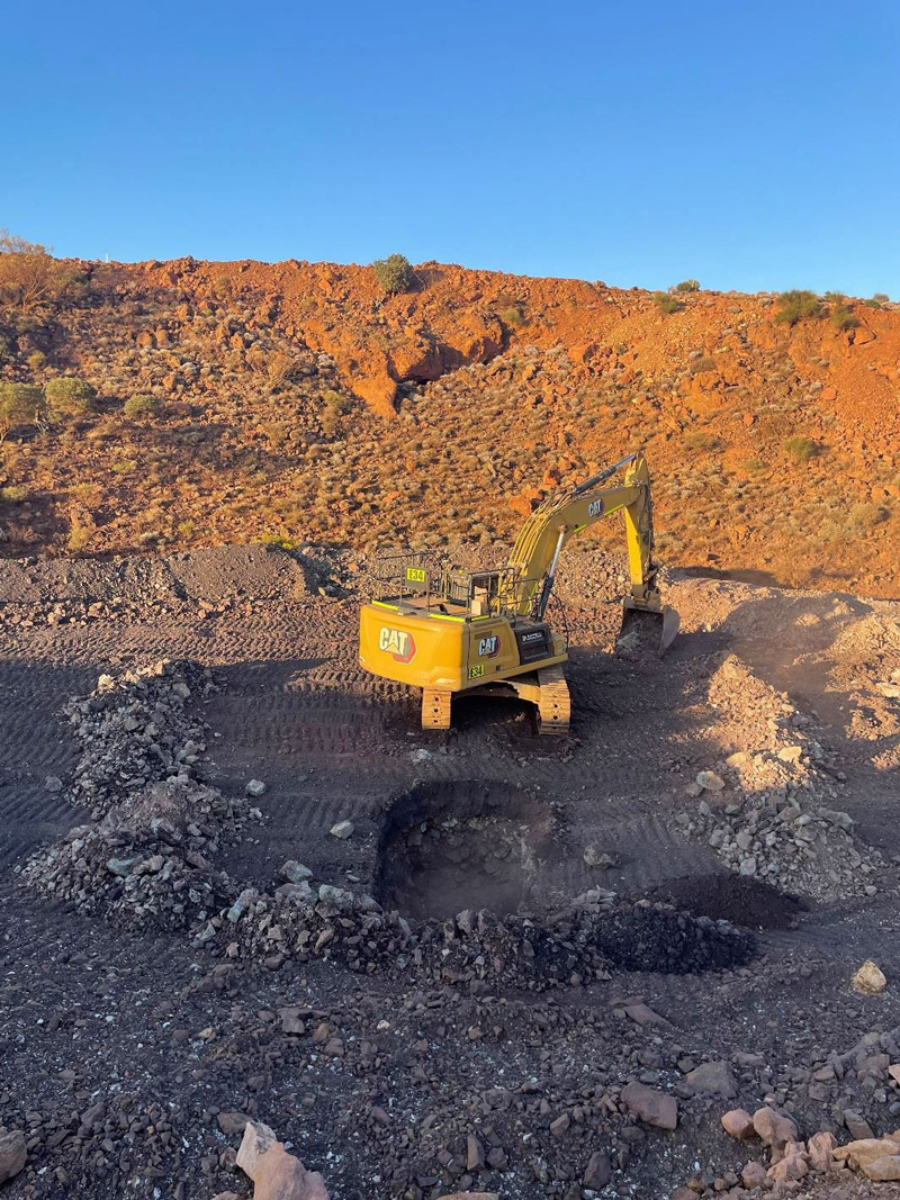 earth moving equipment amongst red dirt