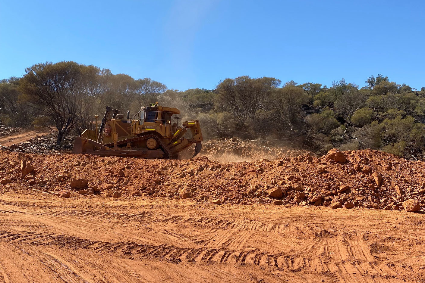 Earthworks machinery operating in red dirt